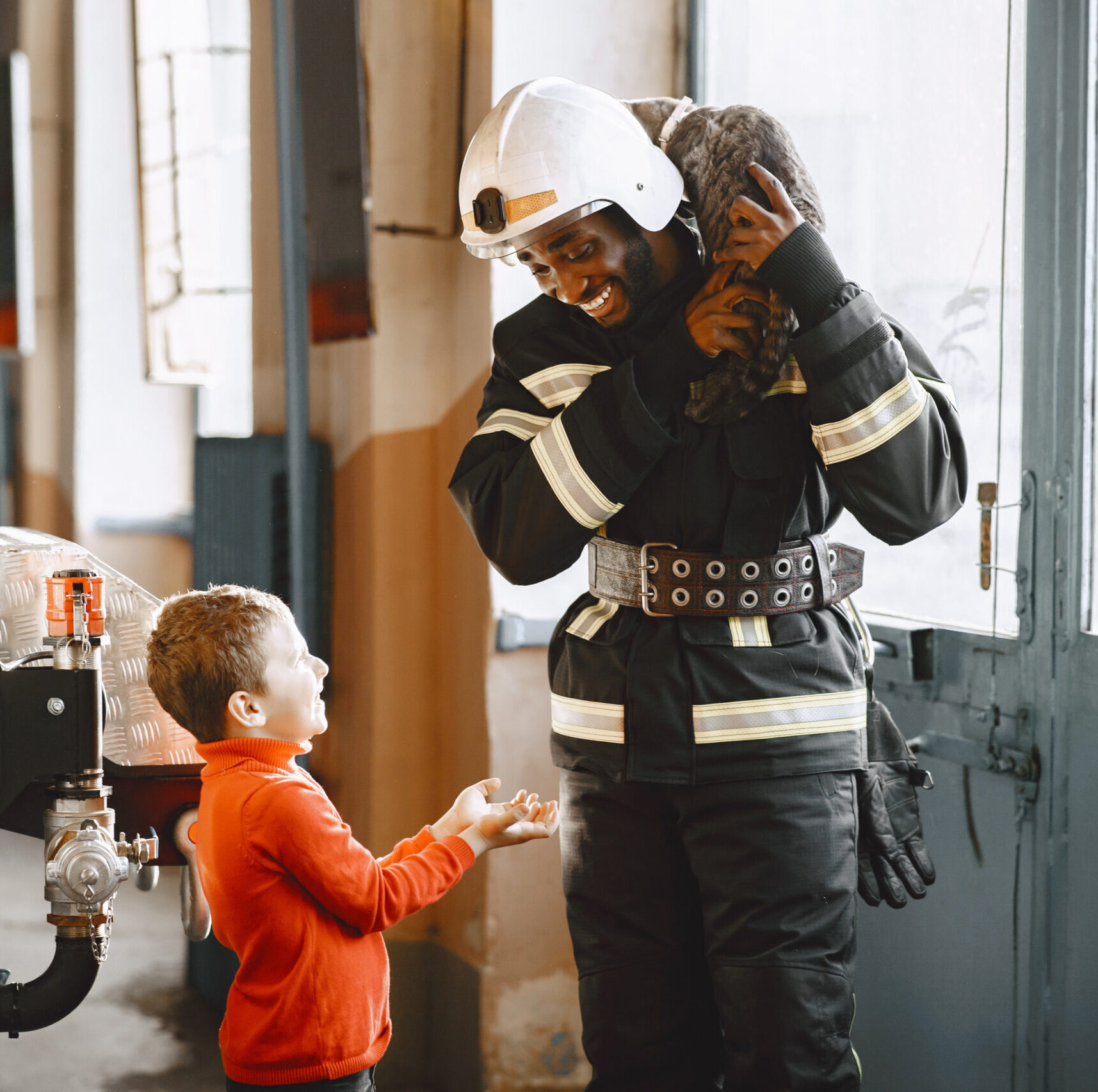 Arfican fireman in a uniform. Man prepare to work. Guy with child.